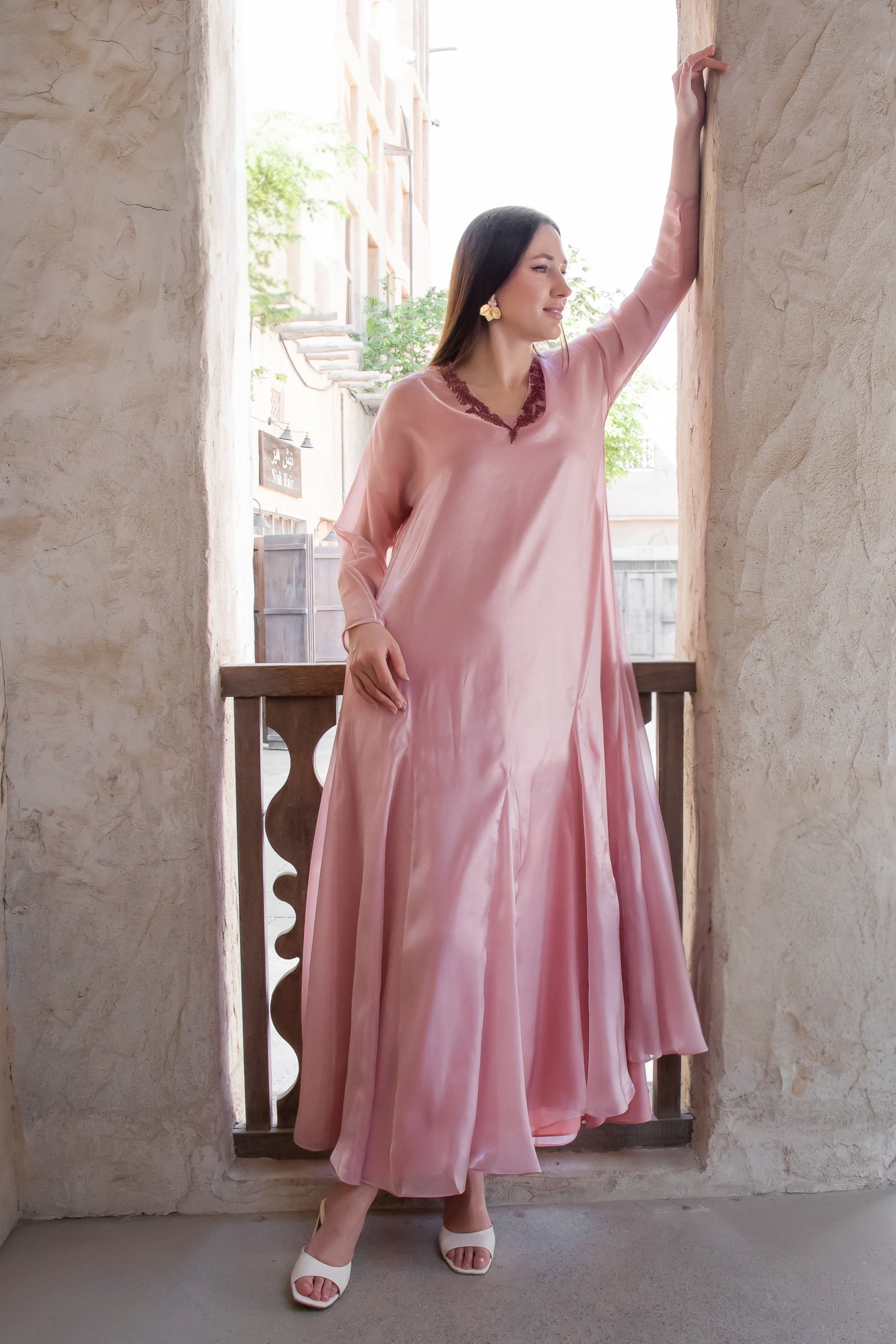 Blush organza Melure by Kunst featuring flowing silhouette and subtle beadwork neckline for elegant occasions

