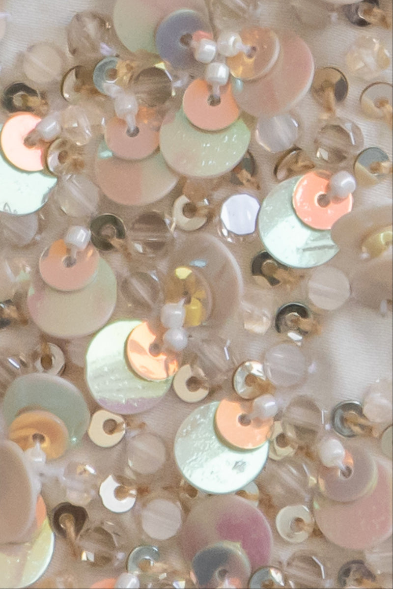 Close up of Sunshine yellow ombré Farasha thobe showcasing delicate 3D bead embellishments and graceful drape
