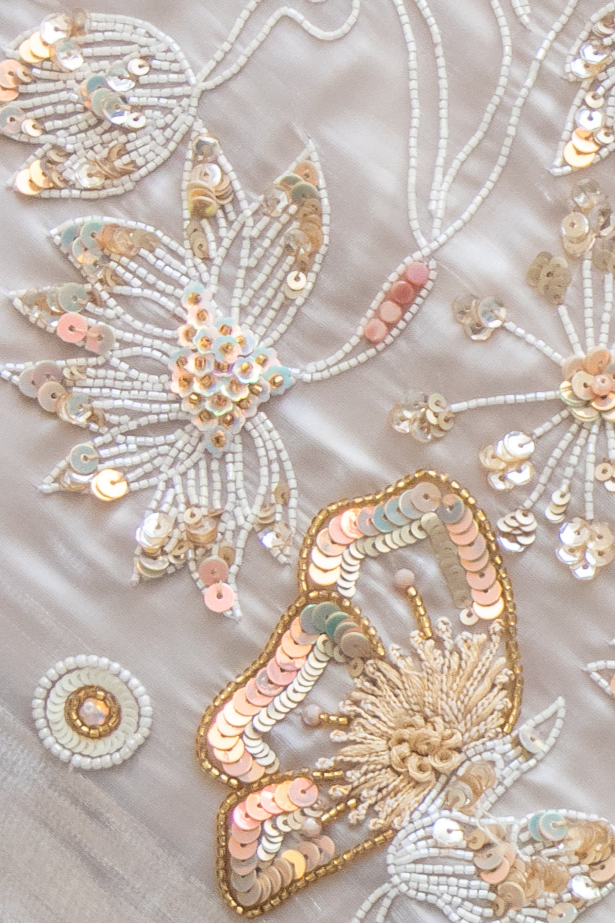 Close up of Flowing Avelyn Kaftan by Kunst in soft champagne organza with regal floral beadwork for evening soirées
