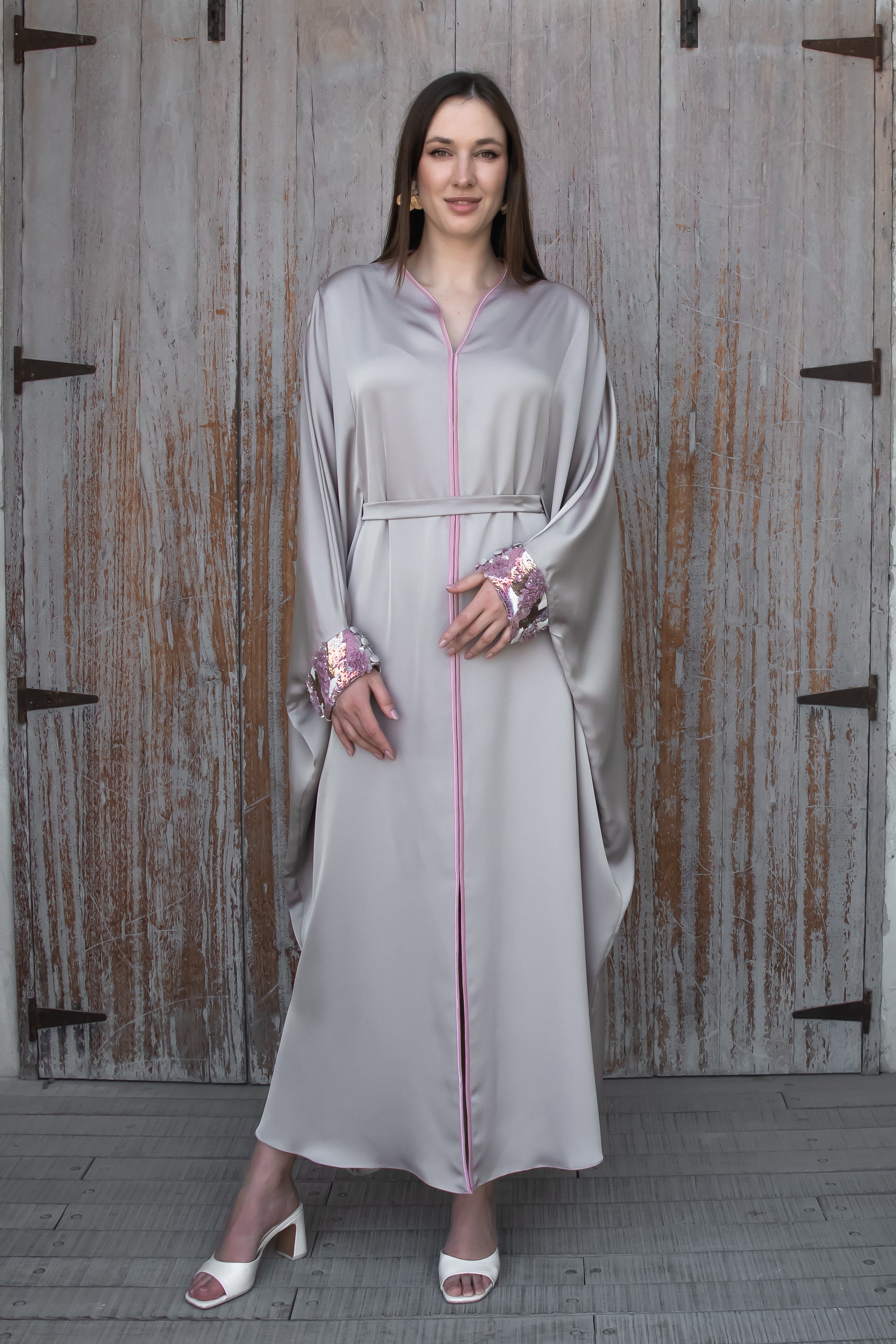 Pastel toned Amira Farasha modest thobe with dramatic open front design and shimmering sequin cuffs
