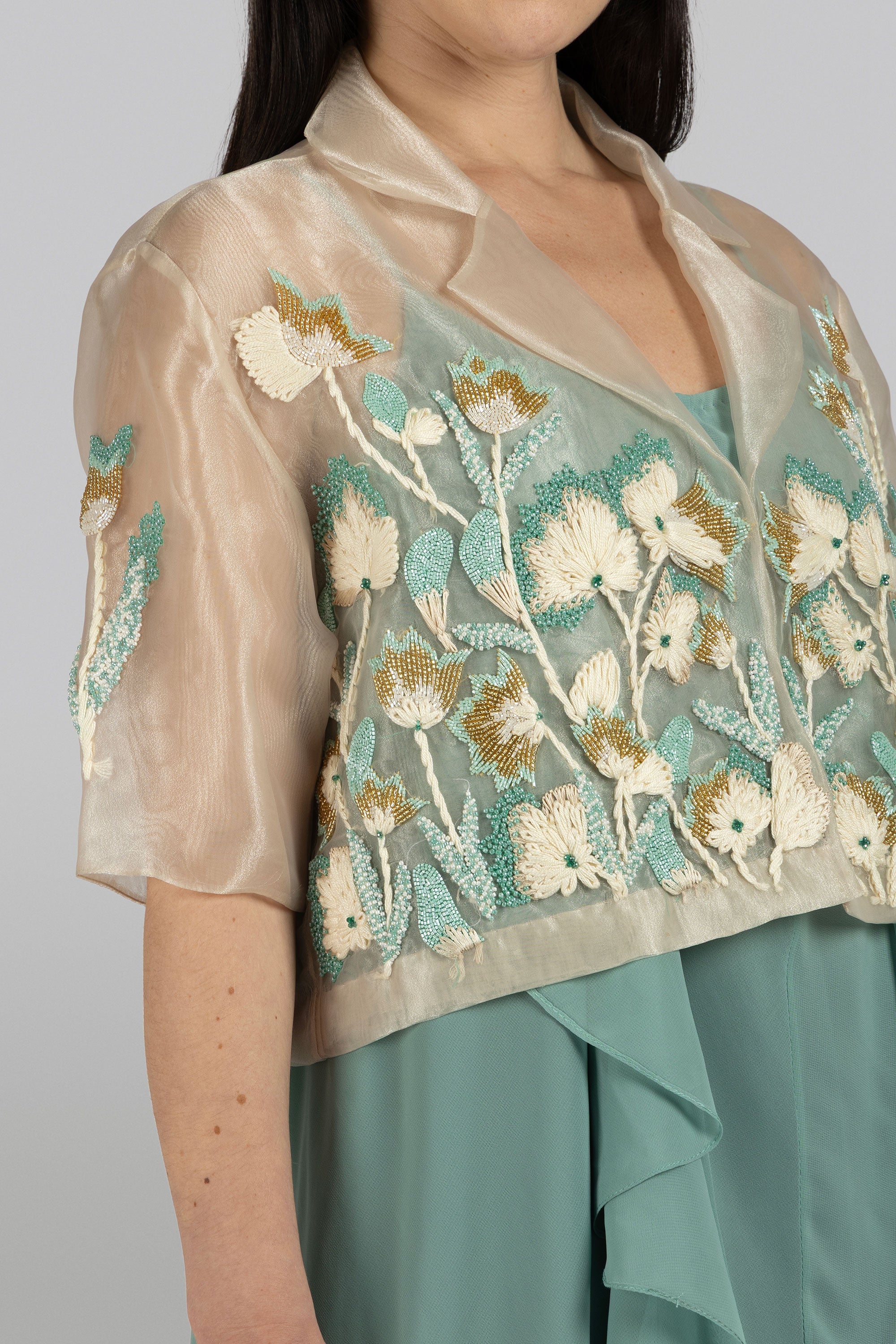 Side view of Lilly Jacket showing delicate organza drape and intricate lily embroidery by KUNST