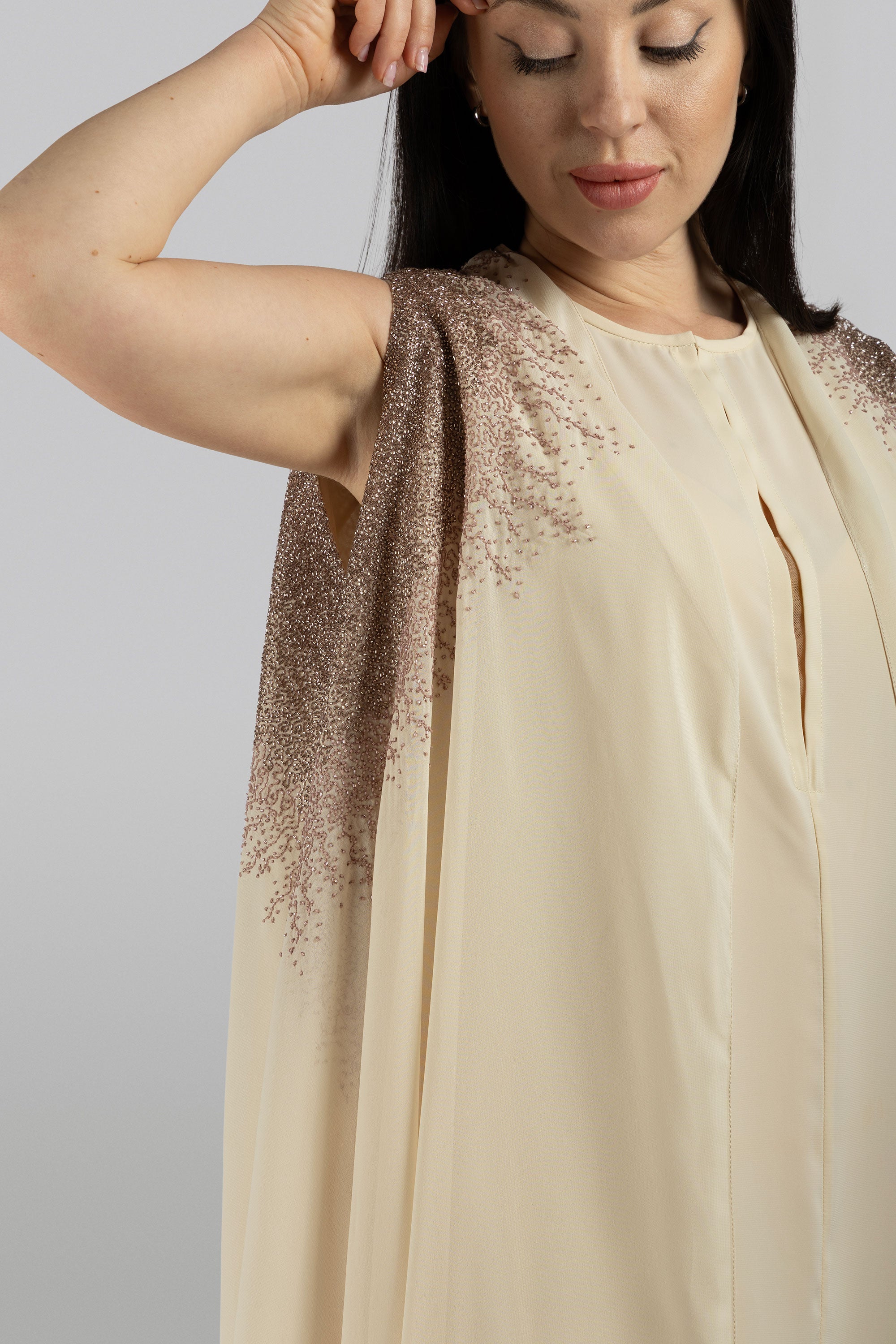 Model wearing thalia hand-embroidered chiffon cape in 3/4 view, showcasing elegant flow and antique beadwork by KUNST UAE
