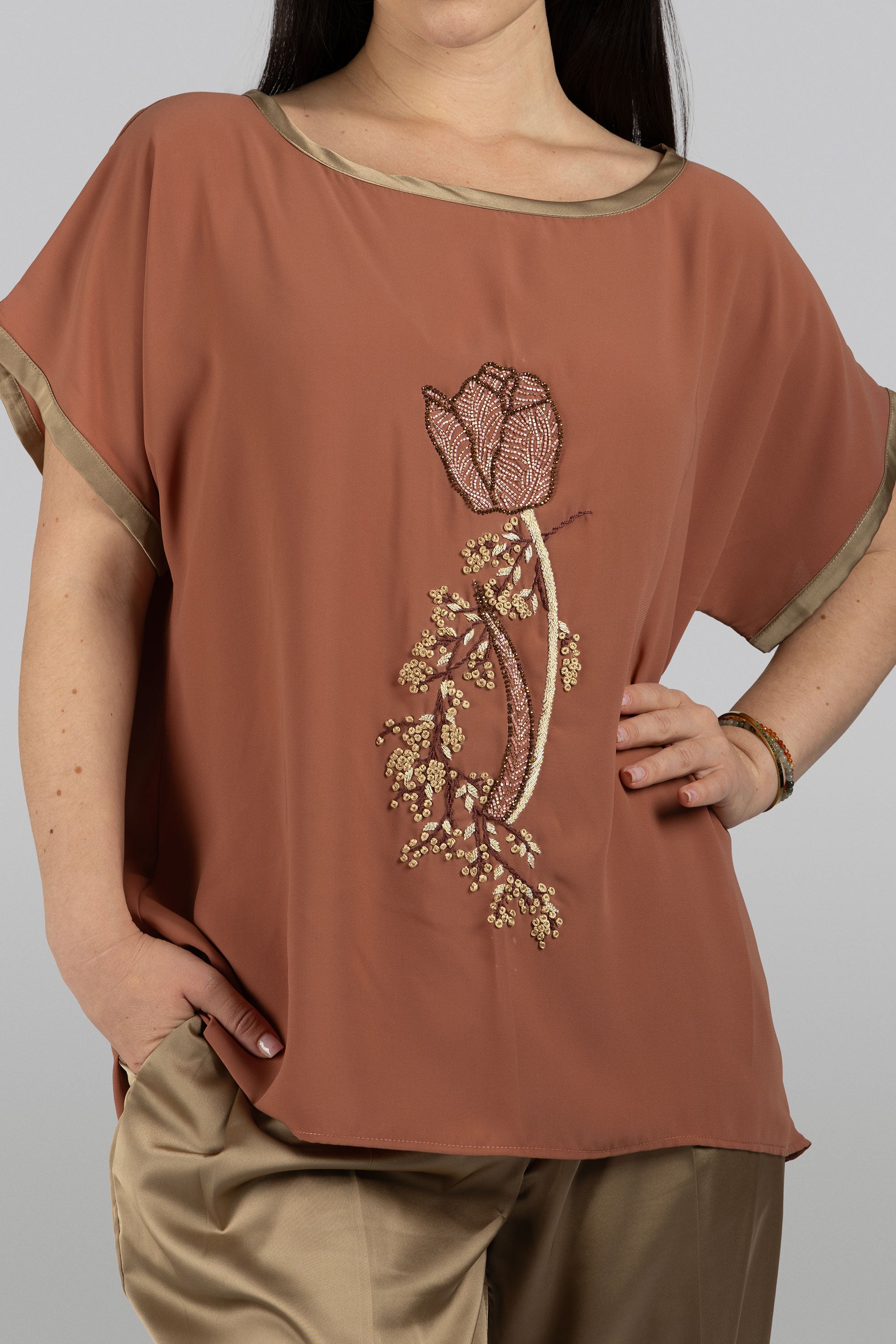Tulip rusty terracotta crepe top with bold round neckline and tulip motif
