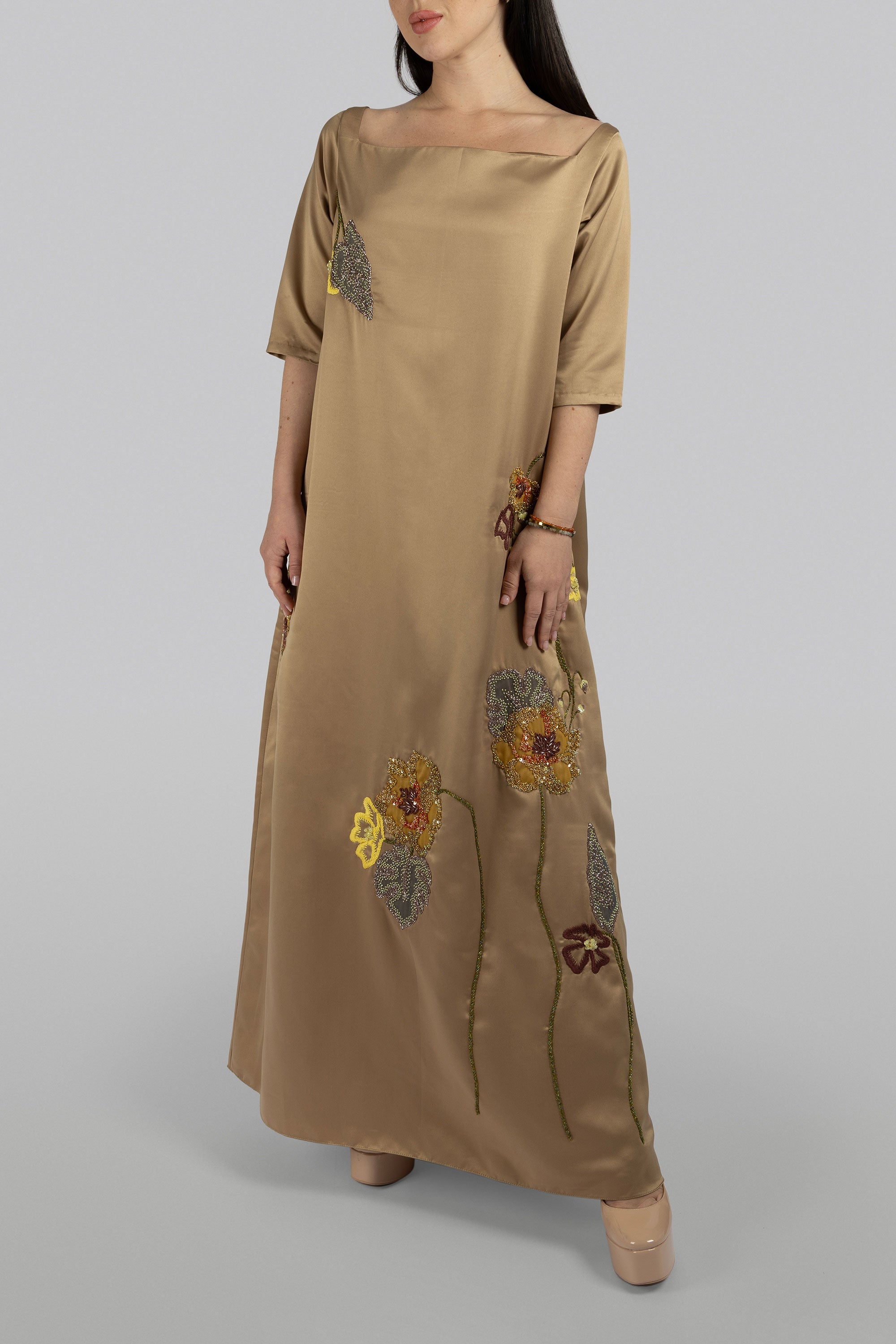 Gold satin A-line maxi dress with carnation-inspired embroidery
