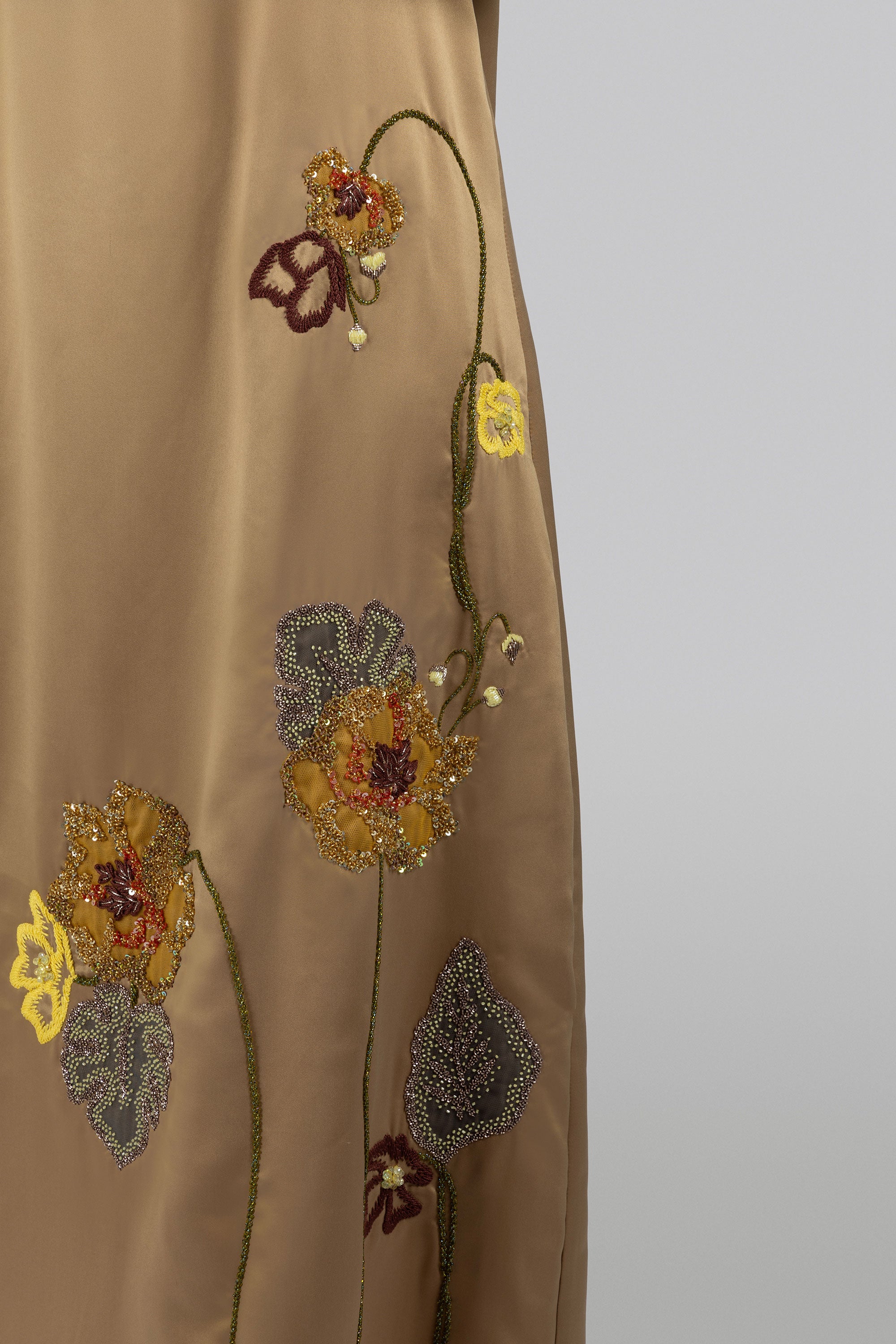 Floral motif gold satin maxi dress with structured silhouette
